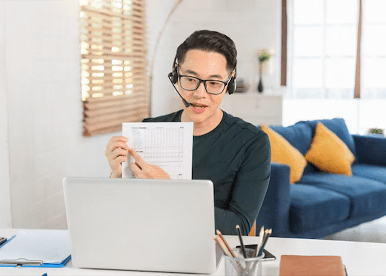 A woman sitting at her desk looking at the paper.